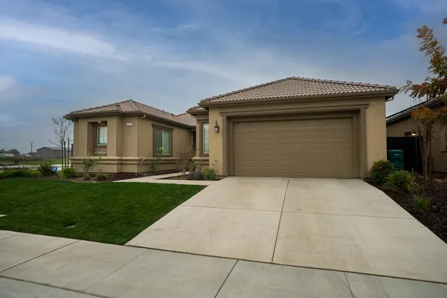 a view of an empty room with wooden floor and a cabinet
