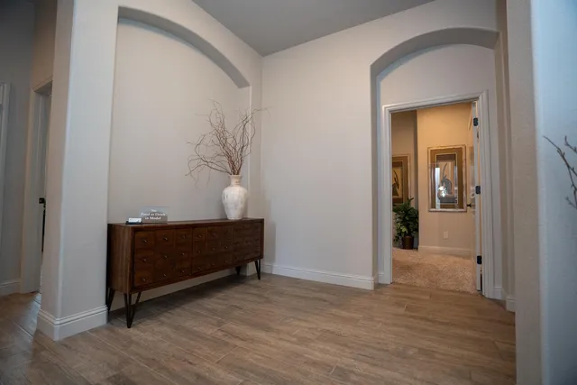 a kitchen with stainless steel appliances kitchen island granite countertop a table chairs sink and cabinets