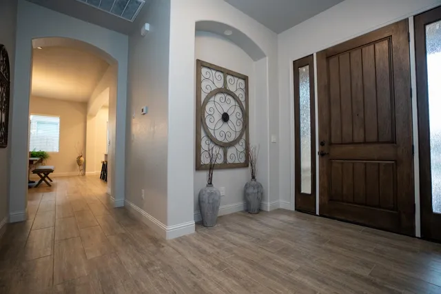 a kitchen with a refrigerator sink and wooden floor
