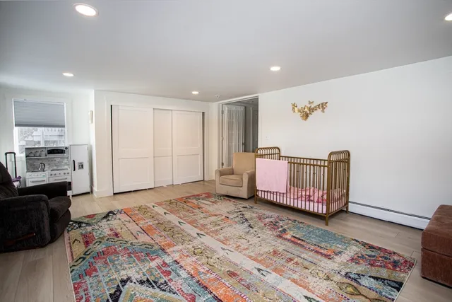 a very nice looking bedroom with a bed and wooden floor