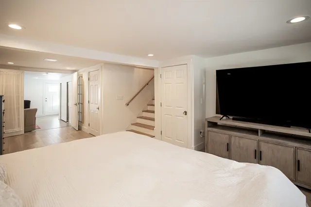 a bedroom with a bed and a flat screen tv