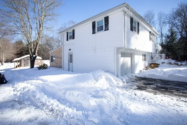 a view of a house with a yard covered in snow