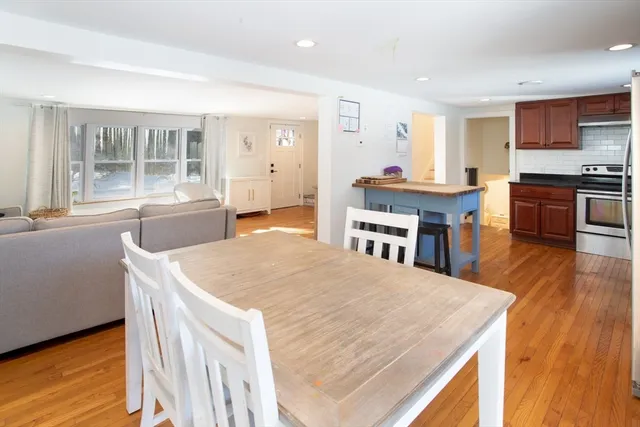 a large kitchen with kitchen island a stove a sink a dining table and chairs