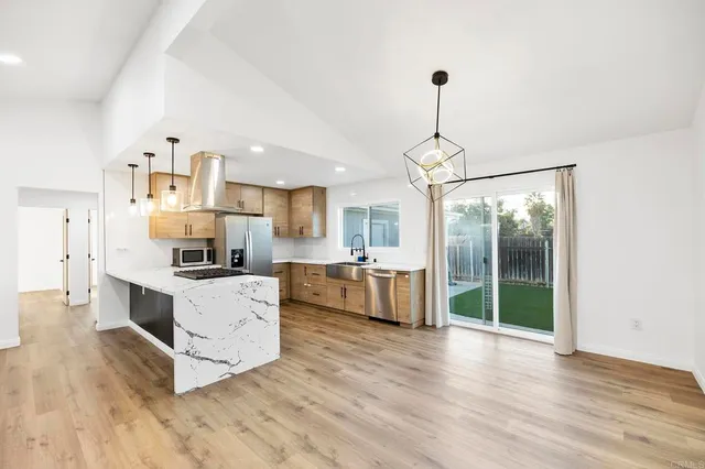 a kitchen with refrigerator a stove top oven and a fireplace