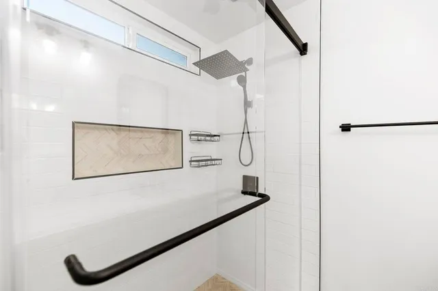 a view of a big room with wooden floor and windows