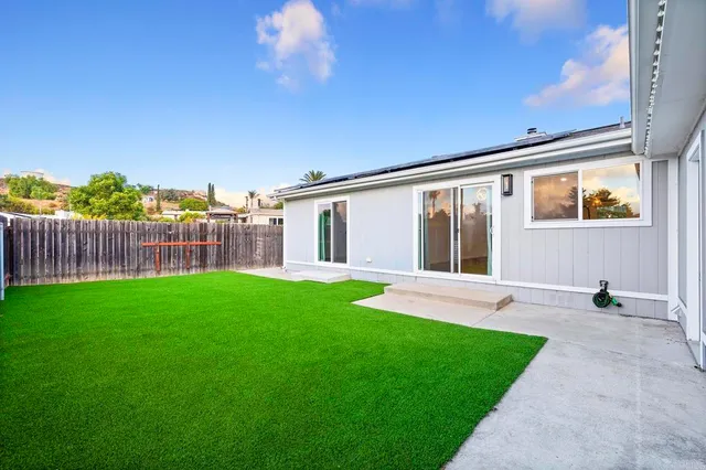 a view of a white house with a yard