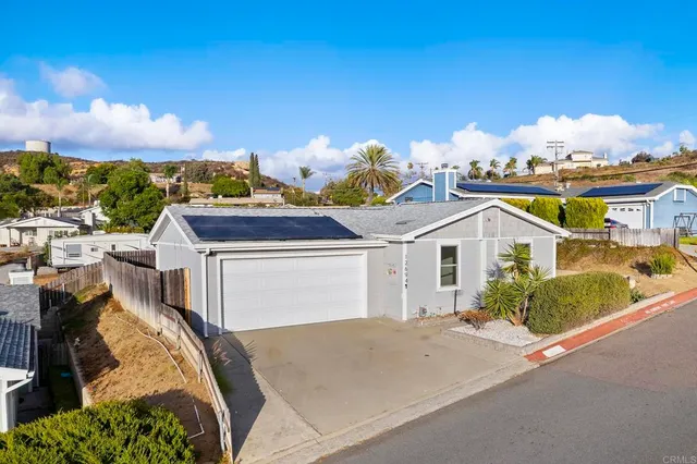 an aerial view of house with yard and swimming pool