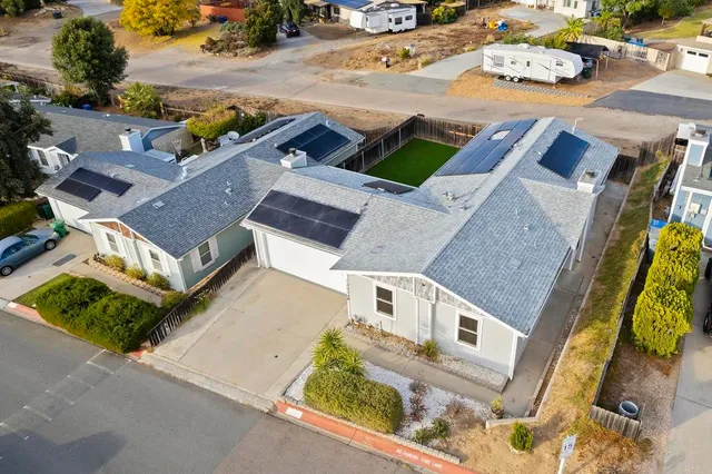 an aerial view of residential houses with outdoor space