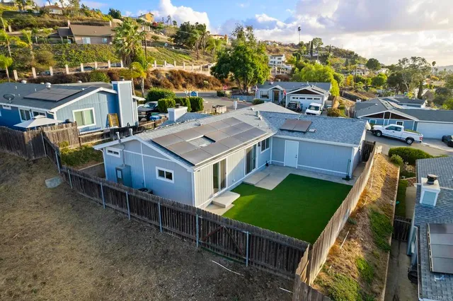 a backyard of a house with lots of green space and garden