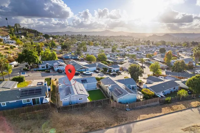 a view of a house with backyard and porch