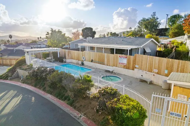 a view of an house with backyard space and balcony