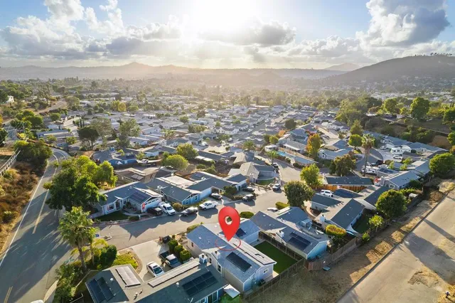 an aerial view of residential houses with outdoor space