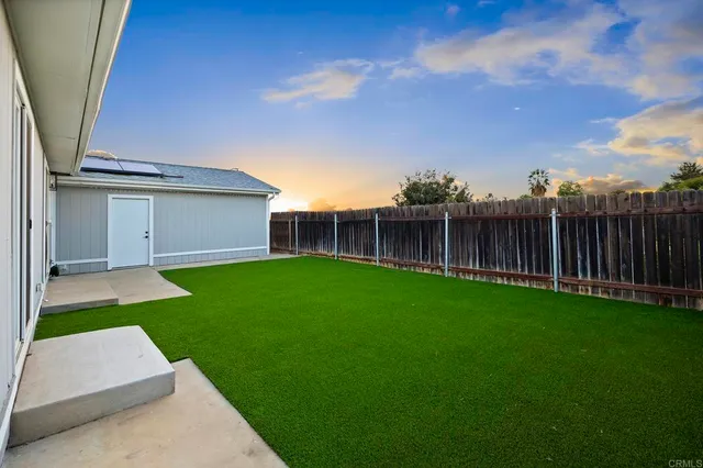 an aerial view of a houses with a swimming pool