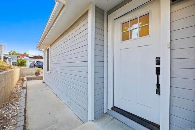 a open kitchen with kitchen island a stove a sink dishwasher and a fireplace with wooden floor