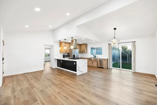 a large kitchen with a lot of counter space and stainless steel appliances
