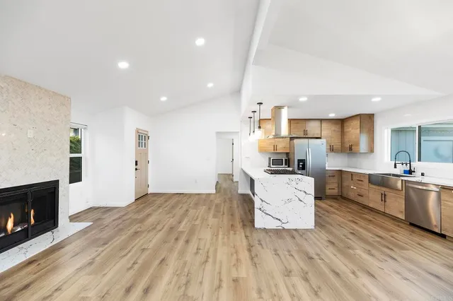 a view of empty room with a fireplace