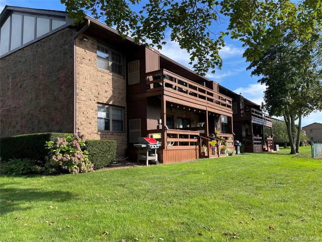 a view of a house with backyard and porch