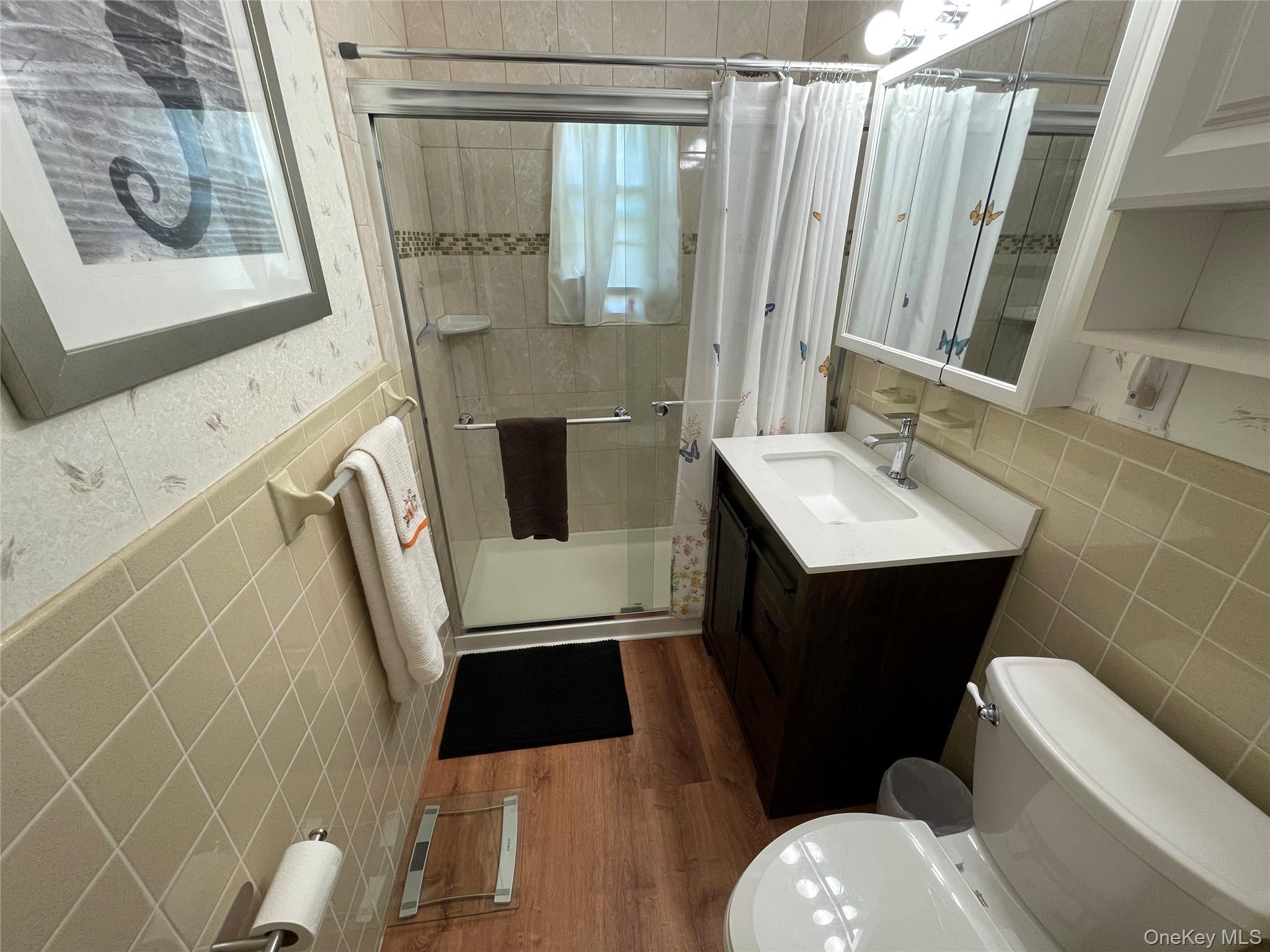 107 Mariners Way Copiague, NY 11726 - Photo 20 of 27 a bathroom with a sink toilet and shower