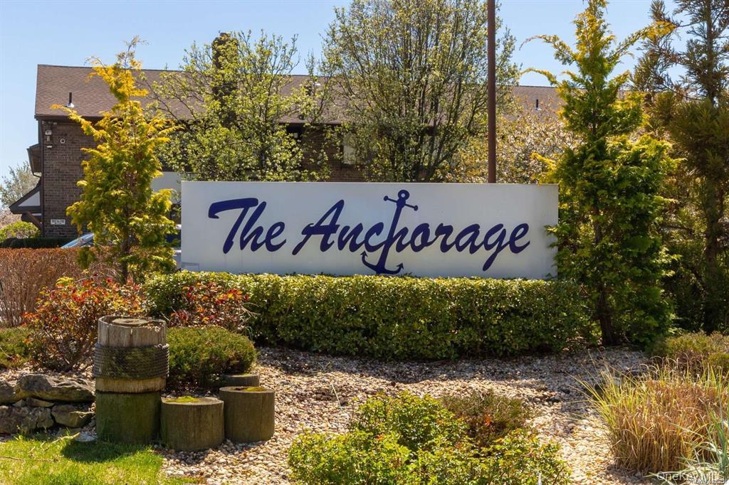 107 Mariners Way Copiague, NY 11726 - Photo 2 of 27 a view of outdoor space with signage and flags