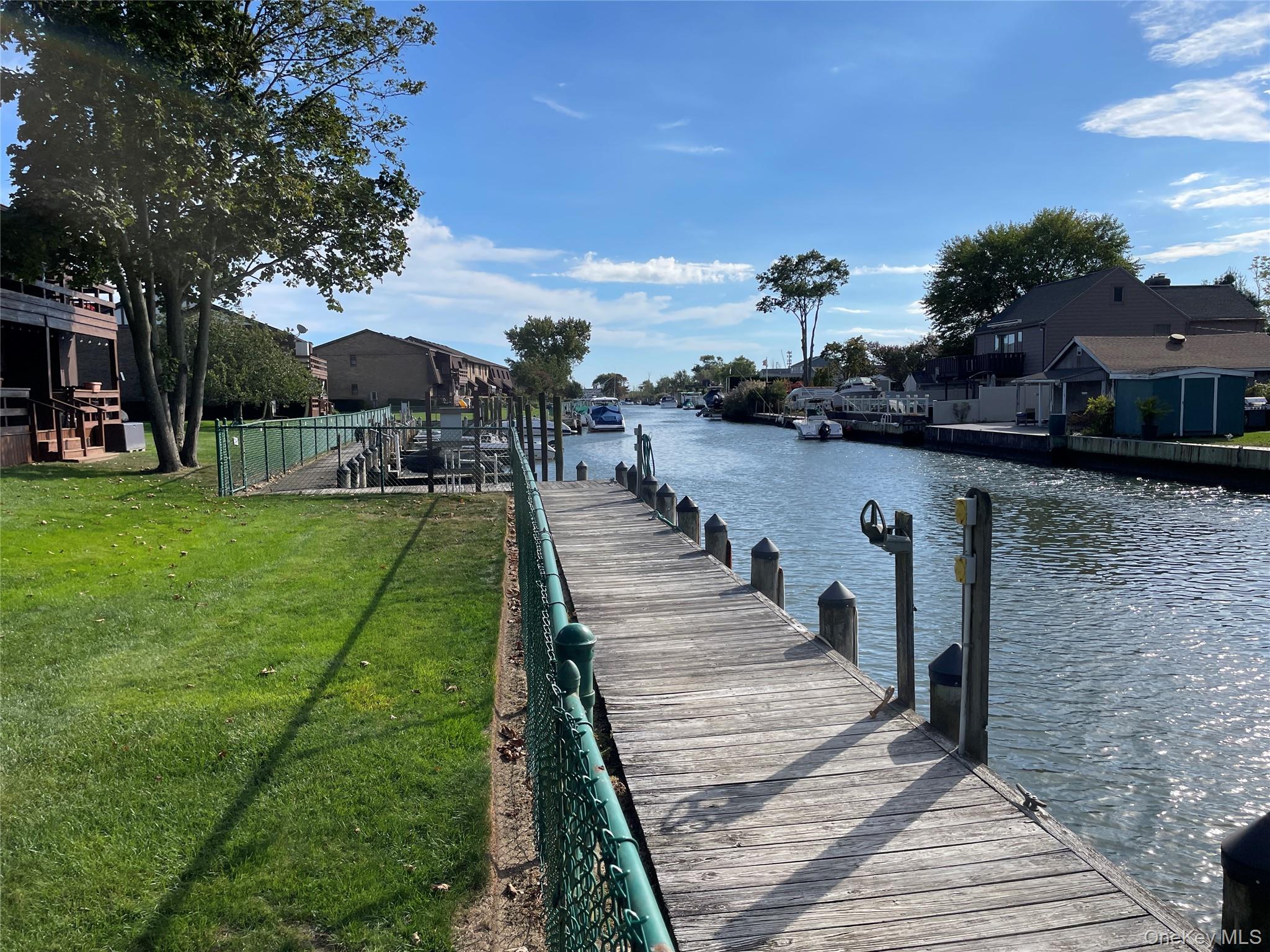 107 Mariners Way Copiague, NY 11726 - Photo 22 of 27 a view of a yard with an outdoor seating