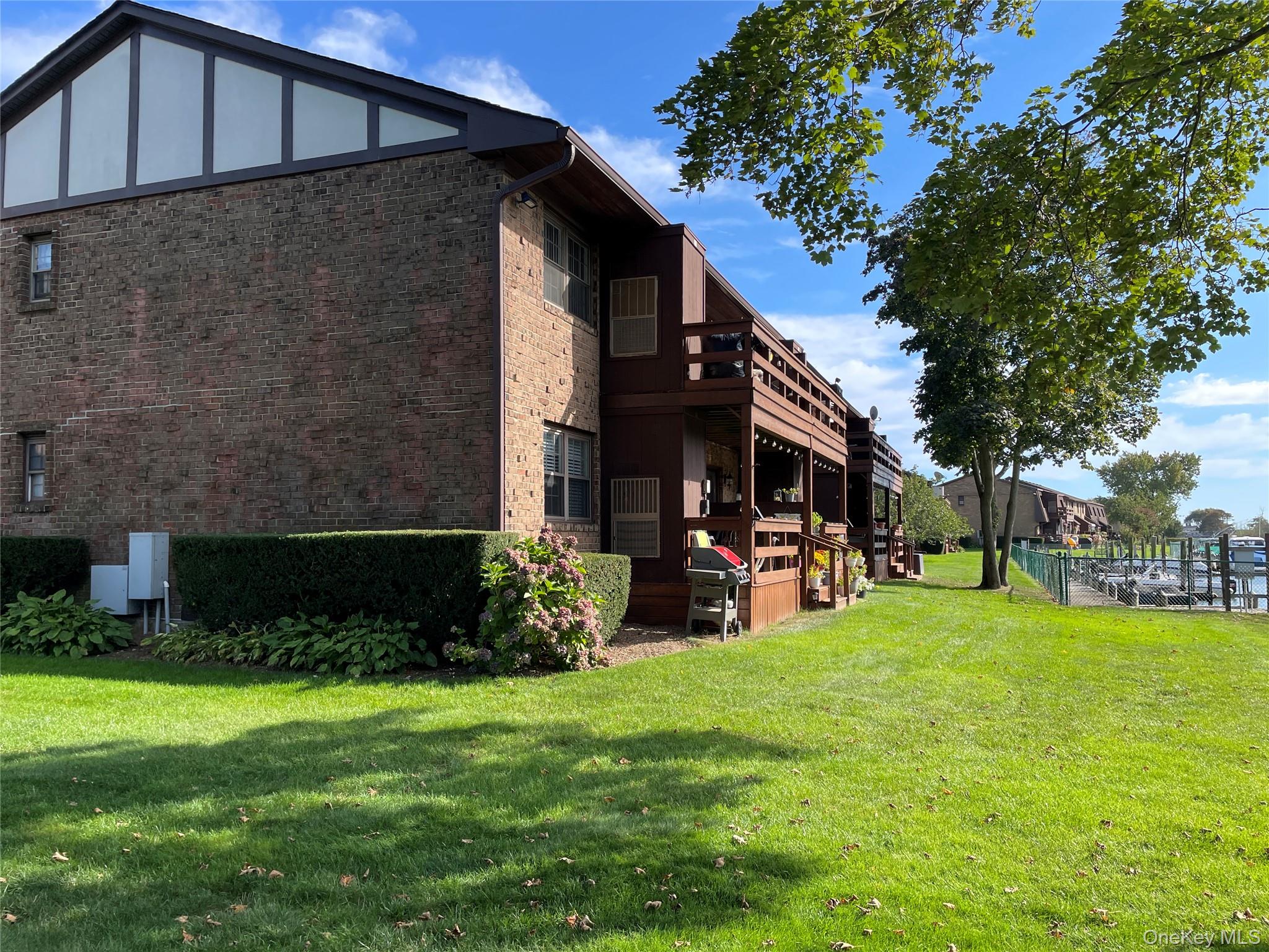 107 Mariners Way Copiague, NY 11726 - Photo 23 of 27 a view of a house with backyard and sitting area