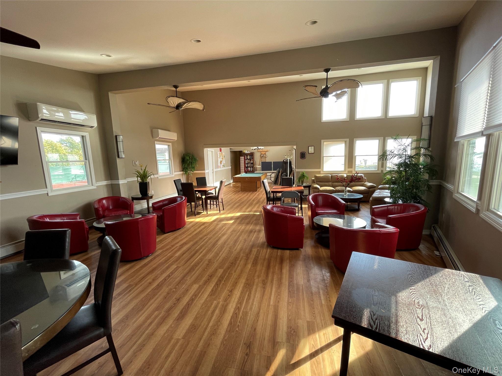 107 Mariners Way Copiague, NY 11726 - Photo 24 of 27 a living room with furniture window and wooden floor