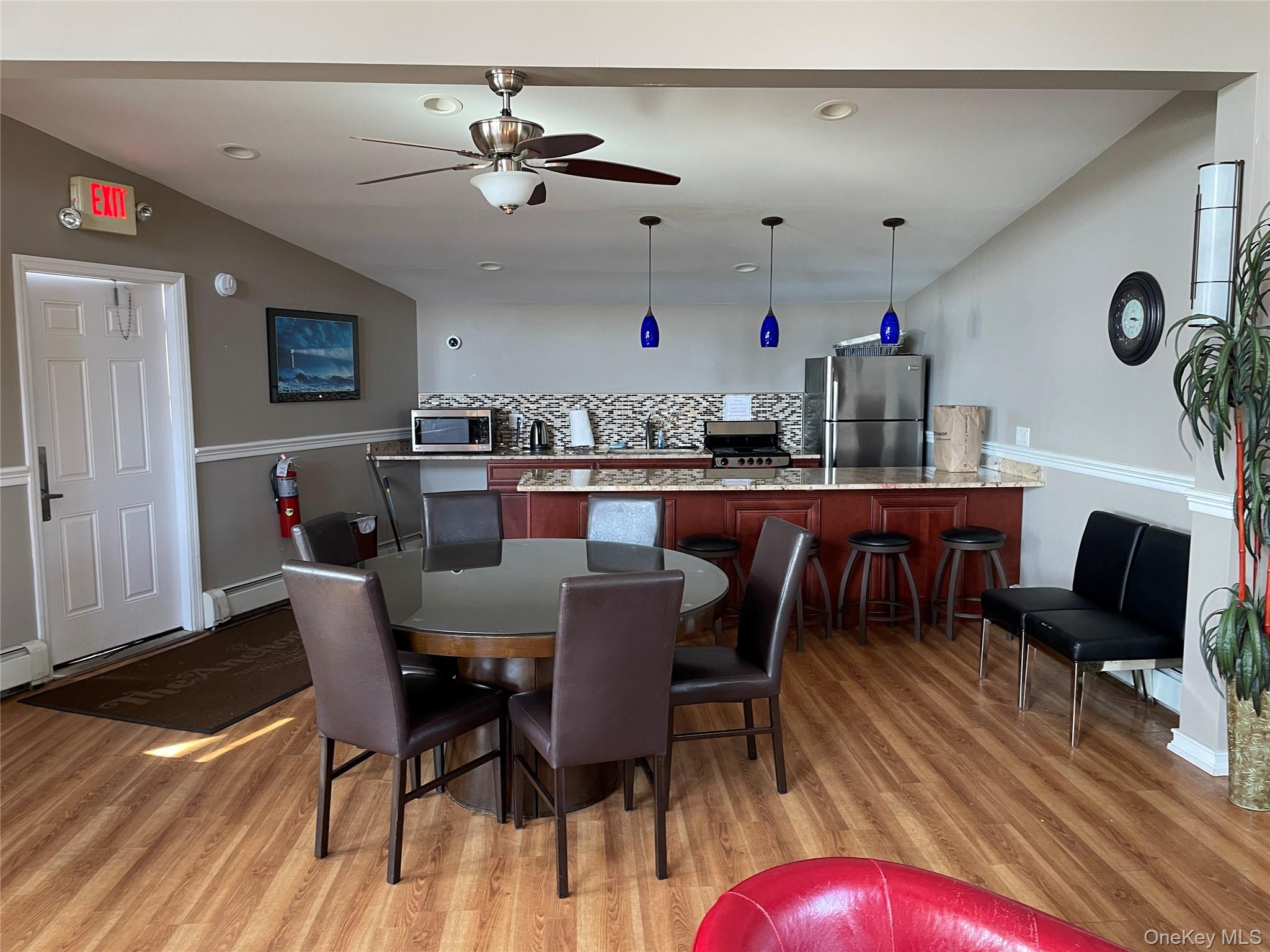 107 Mariners Way Copiague, NY 11726 - Photo 25 of 27 a view of a dining room with furniture and wooden floor