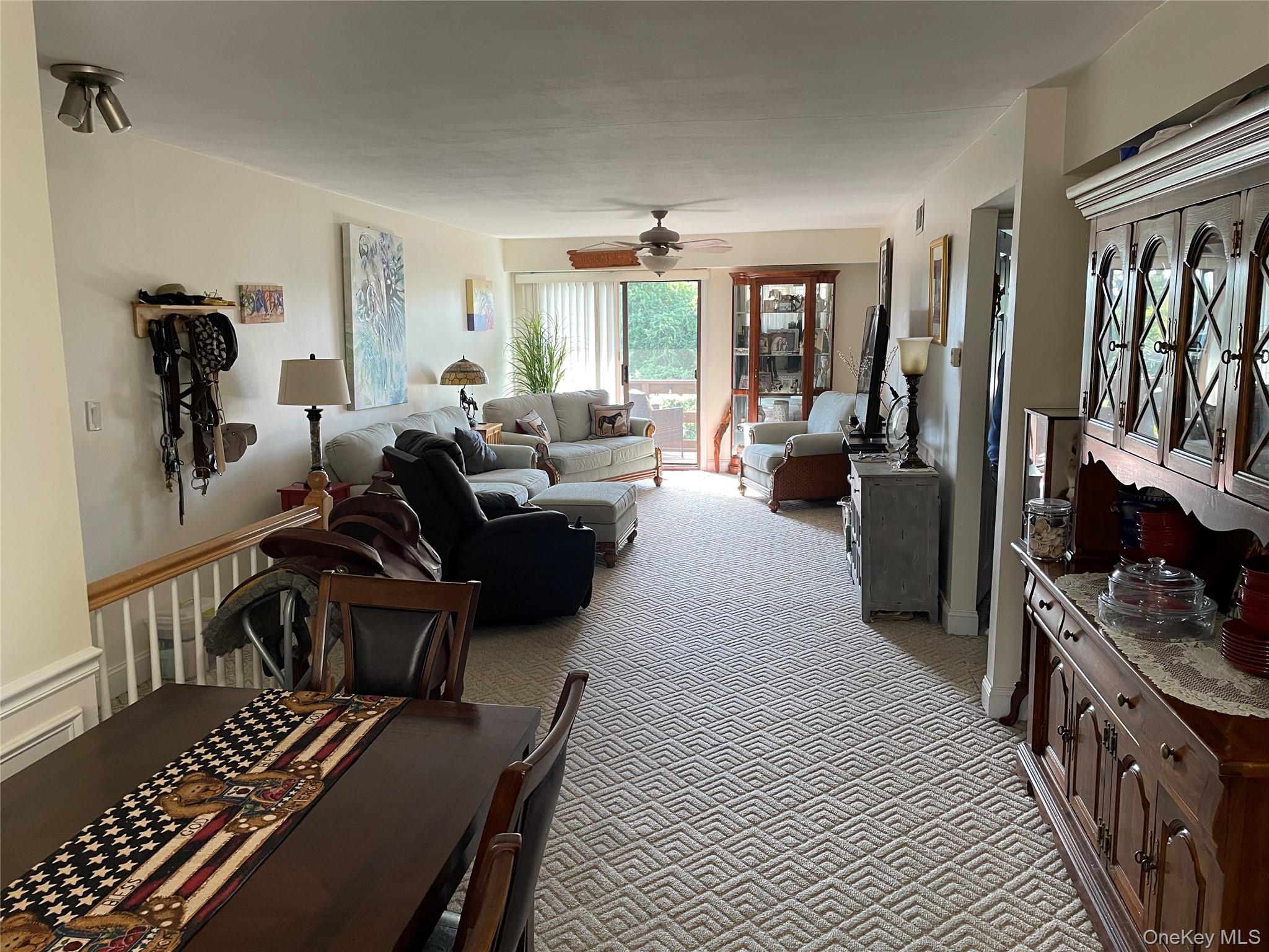 107 Mariners Way Copiague, NY 11726 - Photo 6 of 27 a living room with furniture a flat screen tv and a refrigerator