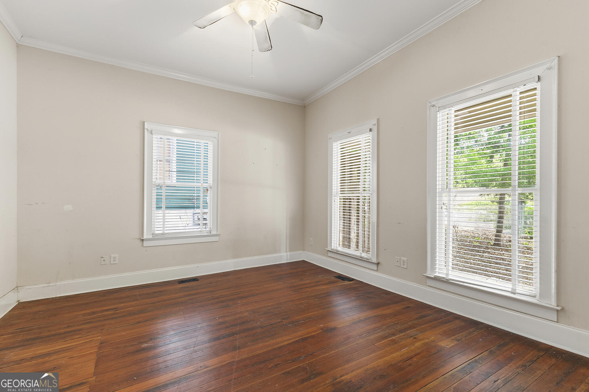1469 Chestnut Street Macon, GA 31201 - Photo 11 of 26 a view of an empty room with wooden floor and a window