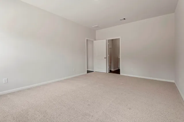 a kitchen with granite countertop white cabinets and stainless steel appliances