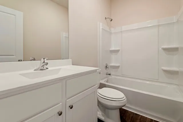 a white toilet sitting next to a bath tub