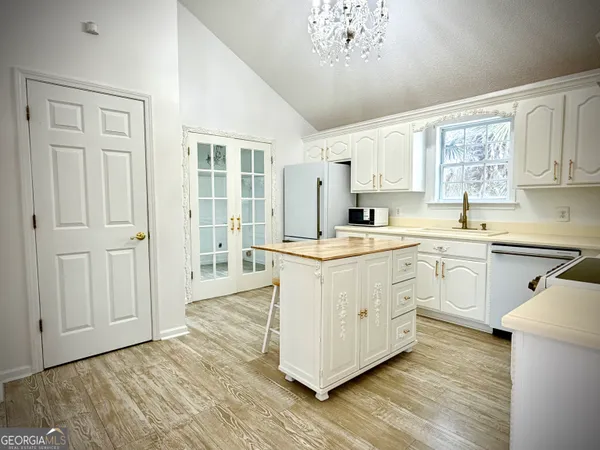 a kitchen with cabinets a sink and appliances