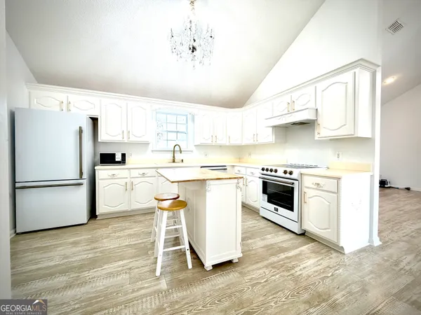 a kitchen with a white cabinets and white appliances