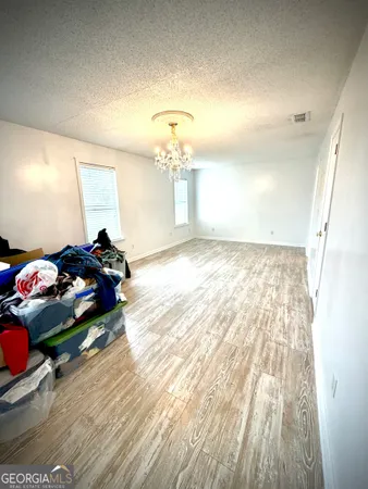 a view of a room with wooden floor