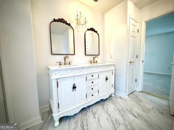 a bathroom with a double vanity sink and mirror