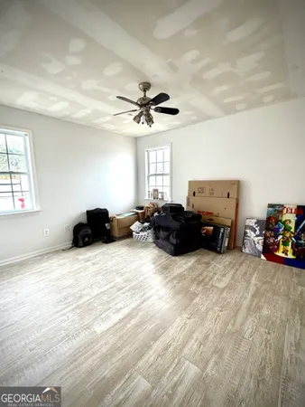 a large bedroom with a bed and a chandelier
