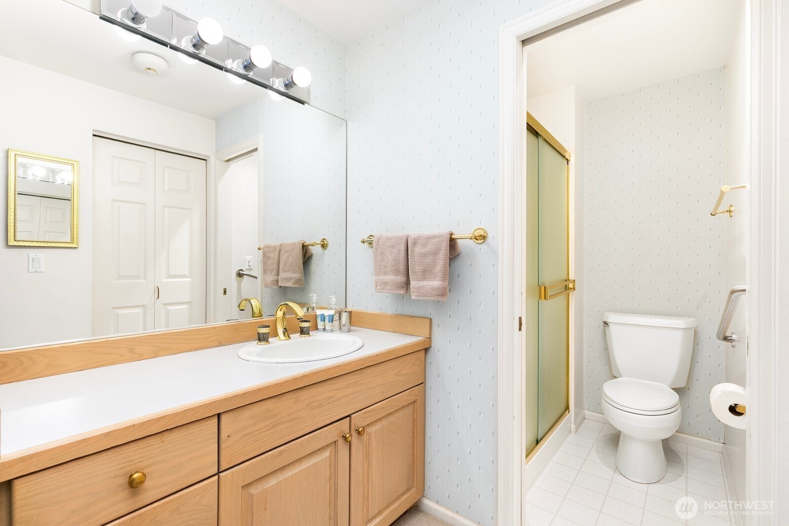 3113 West Harley Street, Unit 3115 Seattle, WA 98199 - Photo 24 of 28 a bathroom with a sink a toilet and a mirror