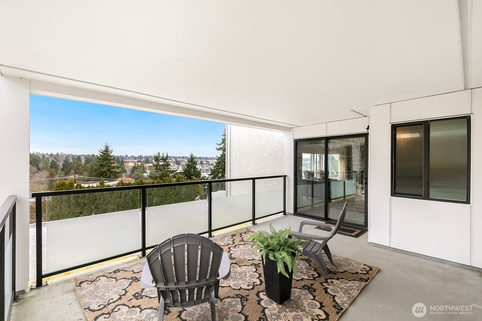 3113 West Harley Street, Unit 3115 Seattle, WA 98199 - Photo 8 of 28 a view of a balcony with chair and potted plant