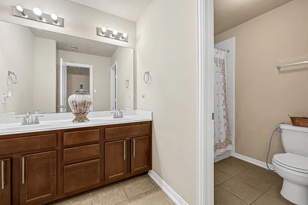 a white toilet sitting next to a shower curtain