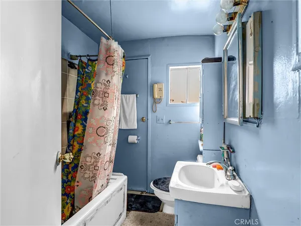 a bathroom with a sink and a shower curtain