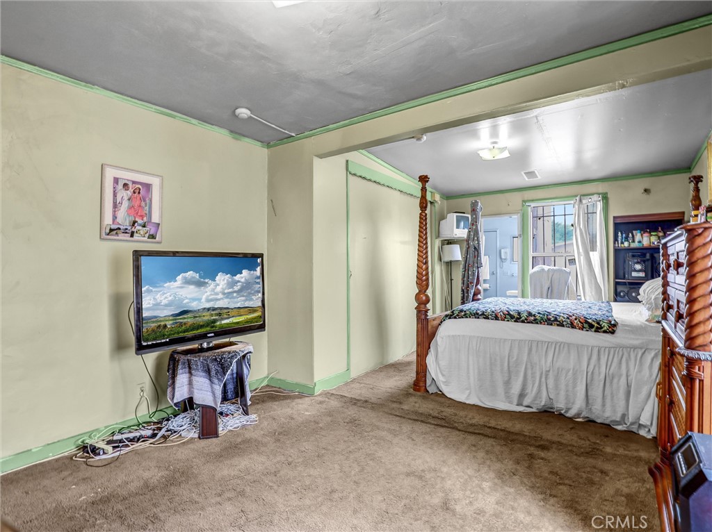 405 South Ward Avenue Compton, CA 90221 - Photo 15 of 28 a bedroom with furniture and a flat screen tv