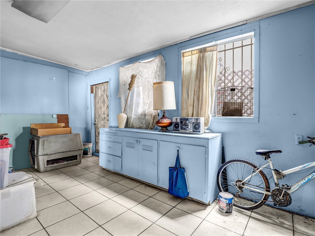 405 South Ward Avenue Compton, CA 90221 - Photo 20 of 28 a room with furniture a window and a potted plant