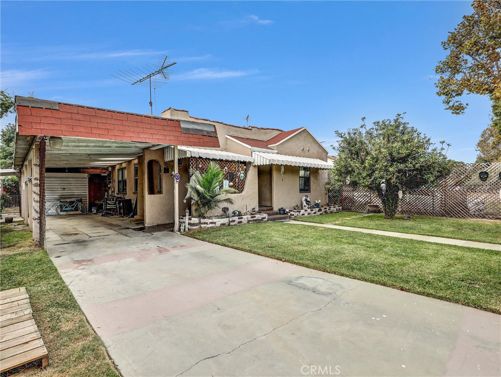 405 South Ward Avenue Compton, CA 90221 - Photo 2 of 28 a front view of a house with a garden