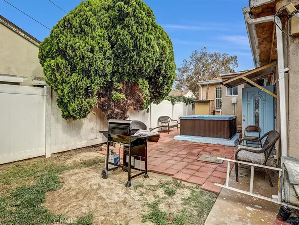 a backyard of a house with table and chairs