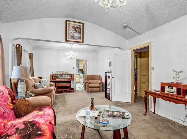 a living room with furniture and a mirror