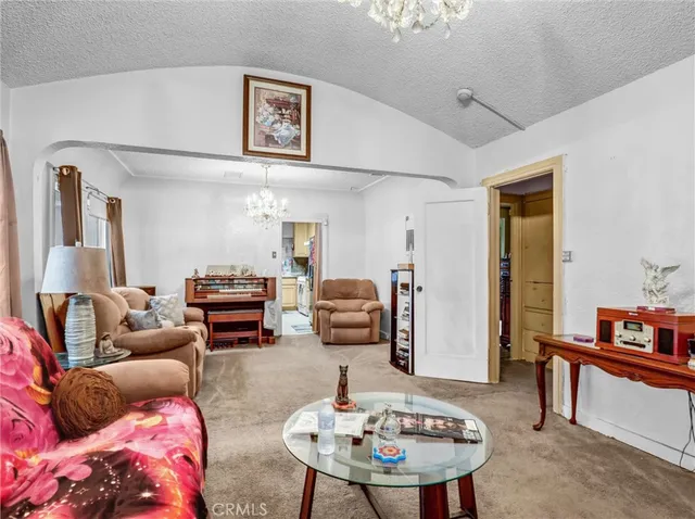 a living room with furniture and a mirror