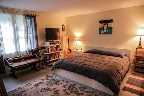 5 Yellow Brick Road Truro, MA 02666 - Photo 16 of 20 a bedroom with a bed and flat screen tv