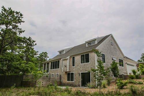 5 Yellow Brick Road Truro, MA 02666 - Photo 3 of 20 a front view of a house with plants and trees