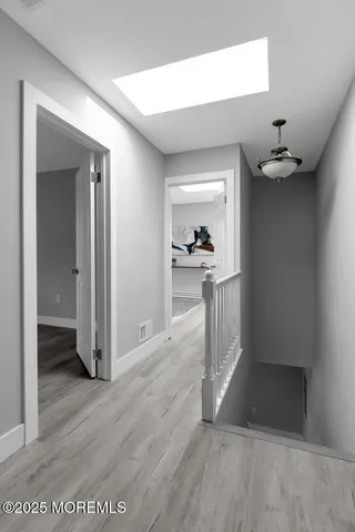 wooden floor in a hall with a living room