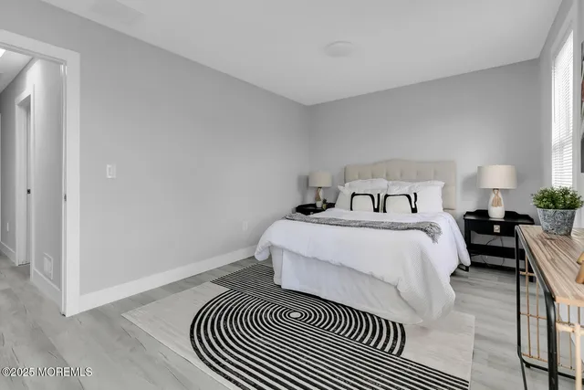 a bedroom with a bed and a night stand